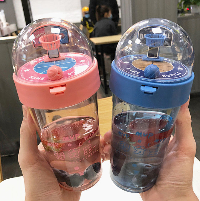 Beckett™ basketball-shaped water bottle with orange and black design, featuring a screw-on lid and textured grip for easy handling.