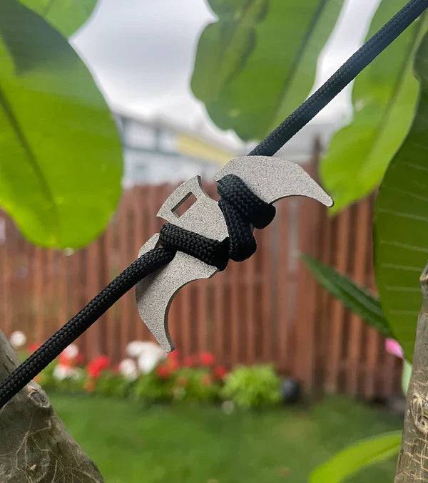 Beckett grappling hook with metal claws and rope, designed for climbing and securing objects in outdoor or tactical settings.